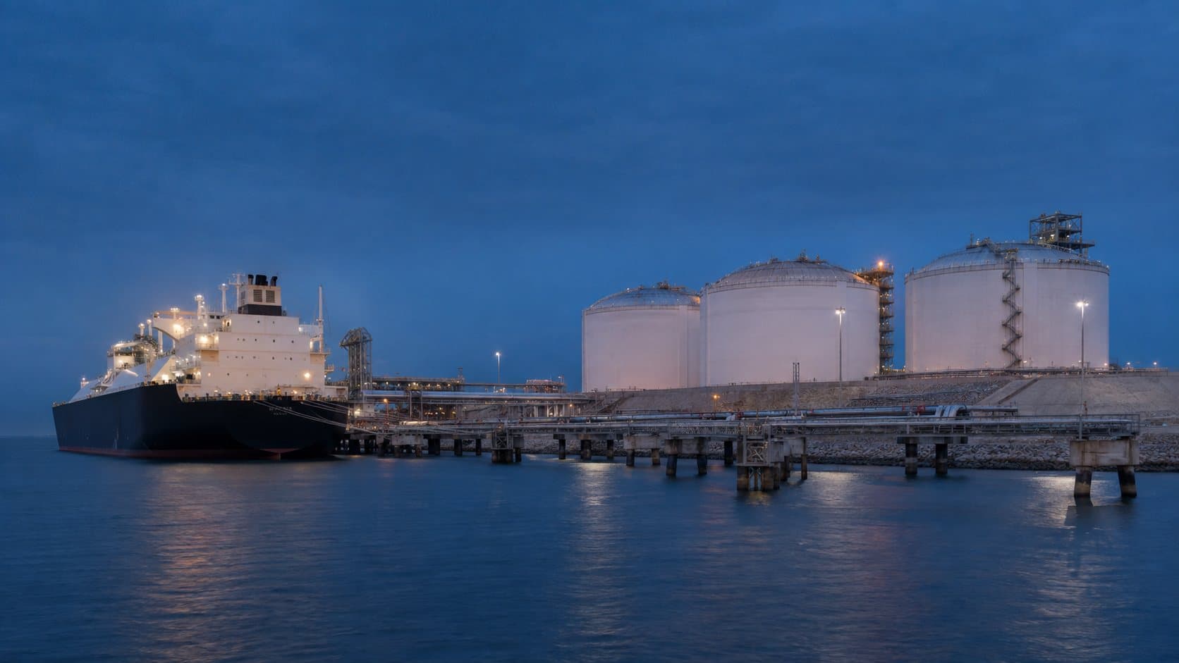 LNG carrier at an export terminal at dusk